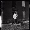 image of Harry Chrisman stands in front of Irvin Green home on the Palo Duro